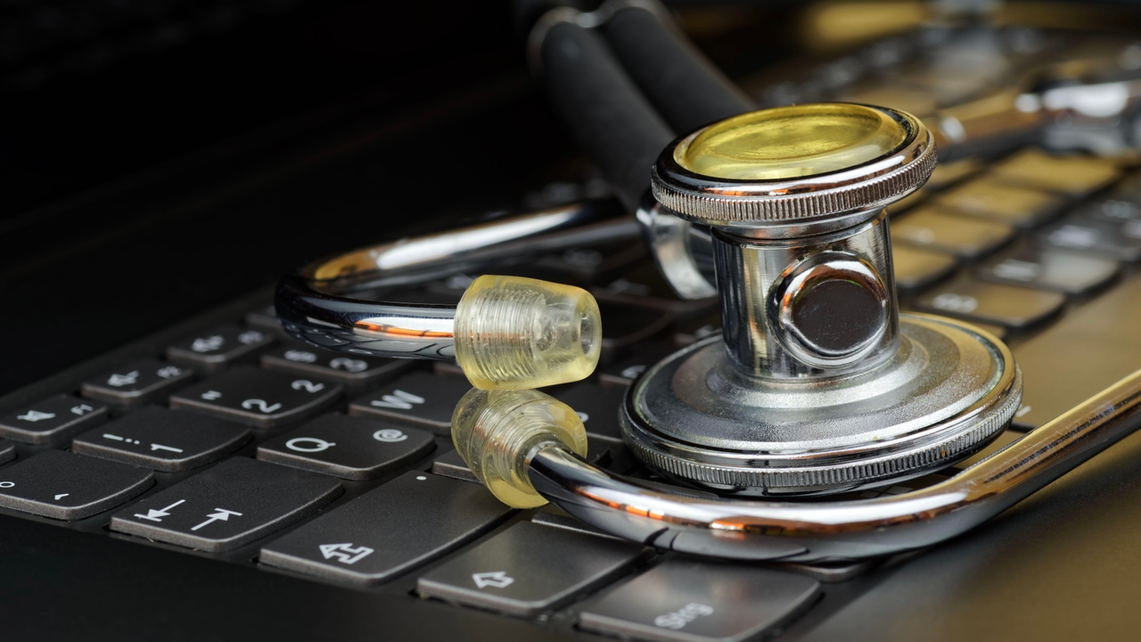 Close-up of stethoscope on black computer keyboard