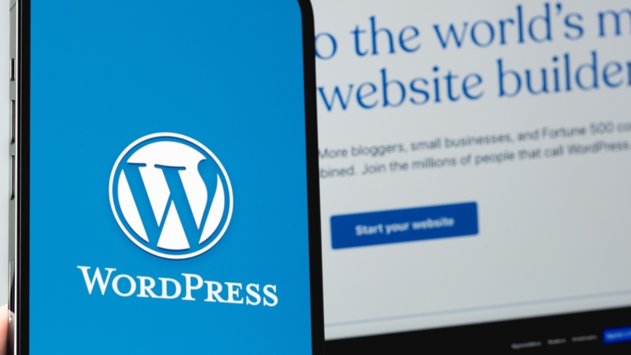 WordPress logo displayed on mobile device screen next to homepage of WordPress website displayed on laptop screen